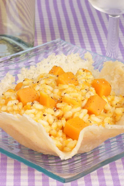 Risotto with pumpkin in a cheese basket — Stock Photo, Image