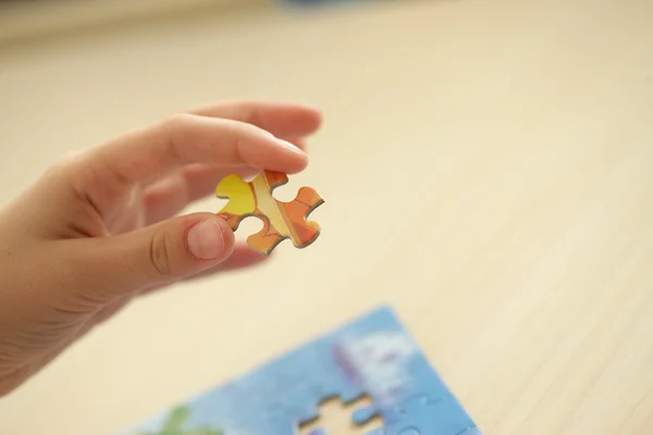Final Piece. Child's hand, inserting missing piece of blank puzz — Stock Photo, Image