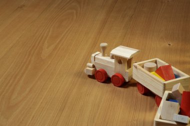 Woodden train toy on parquet. clipart