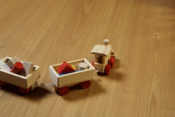 Woodden train toy on parquet. — Stock Photo, Image