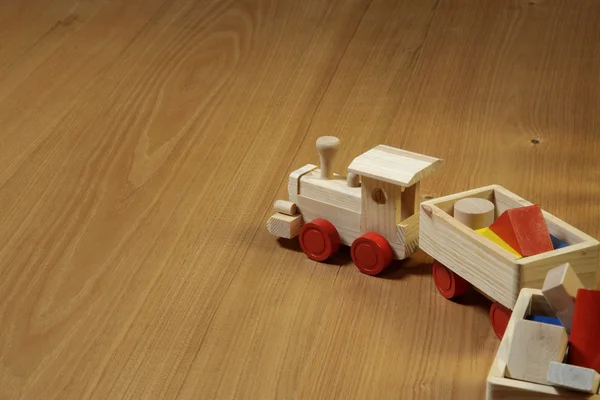 Woodden train toy on parquet. — Stock Photo, Image