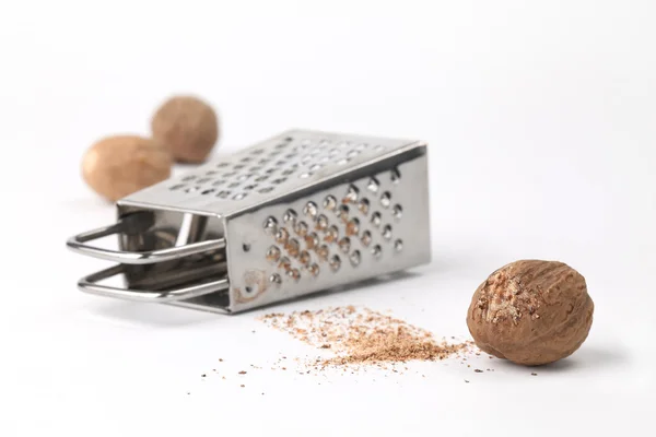 Nutmegs and grater — Stock Photo, Image