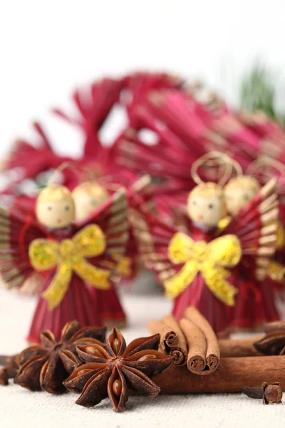 Spices with straw Christmas angels — Stock Photo, Image
