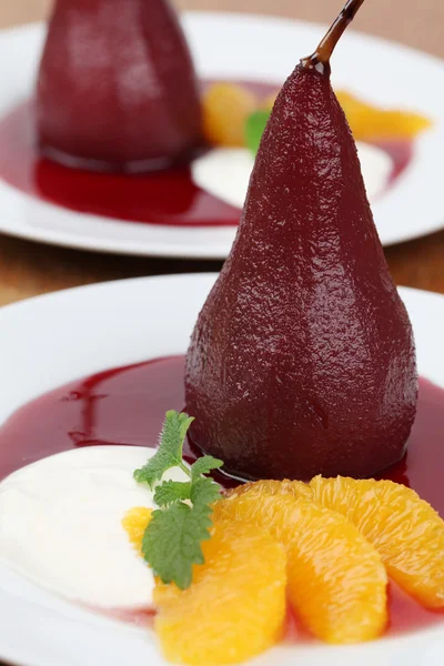 Poached pears in red wine with oranges and creme fraiche — Stock Photo, Image