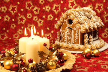 Christmas decoration with candles and gingerbread house clipart