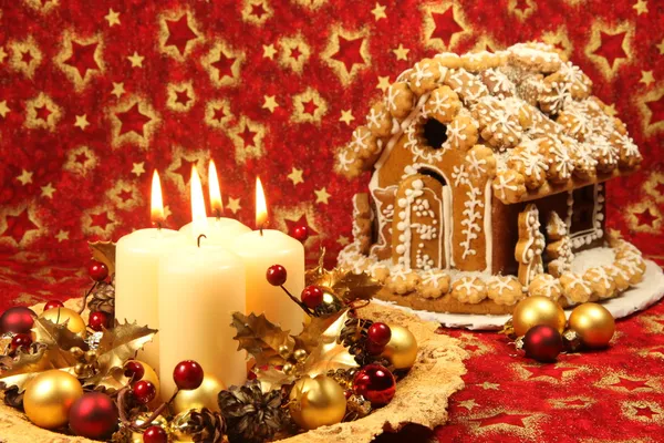 Kerstdecoratie met kaarsen en peperkoek huis — Stockfoto