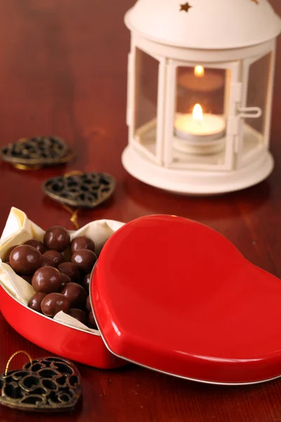 Heart shaped box with chocolate and lantern — Stock Photo, Image