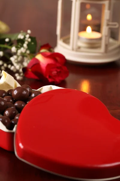 Heart shaped box with chocolate, rose and lantern — Stock Photo, Image
