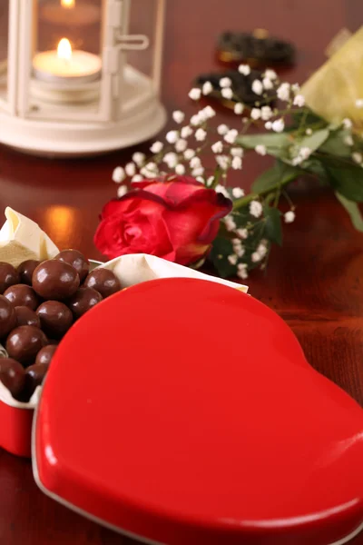 Heart shaped box with chocolate, rose and lantern — Stock Photo, Image