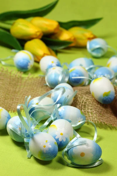 Blue Easter eggs and yellow tulips — Stock Photo, Image
