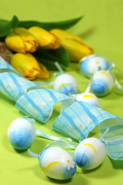Kék húsvéti tojás és a sárga tulipánok — Stock Fotó
