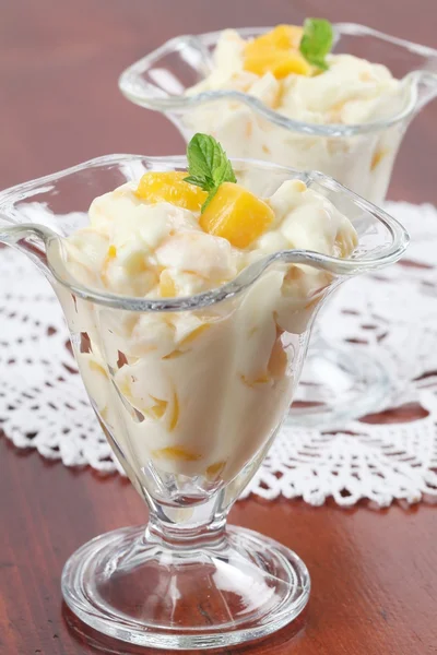 Yogurt dessert with peaches Stock Image