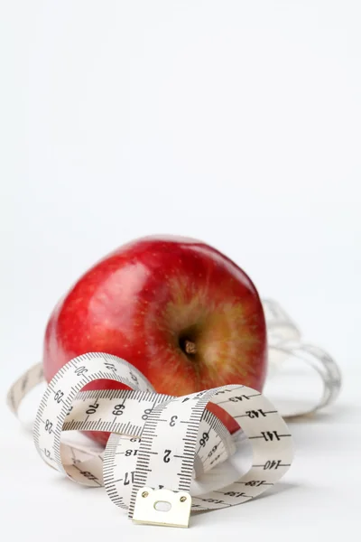 Svinovací metr a červené jablko — Stock fotografie