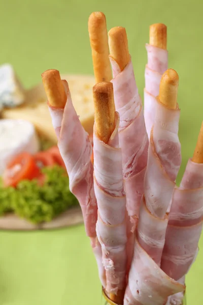 Bacon wrapped grissini and cheese — Stock Photo, Image