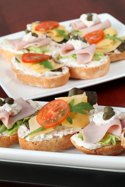 Cheese and ham appetizers — Stock Photo, Image
