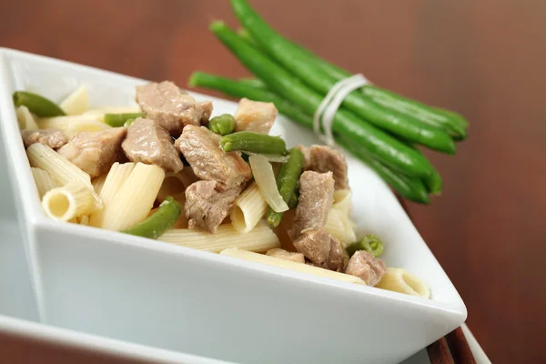 Penne rigate with pork and green beans — Stock Photo, Image