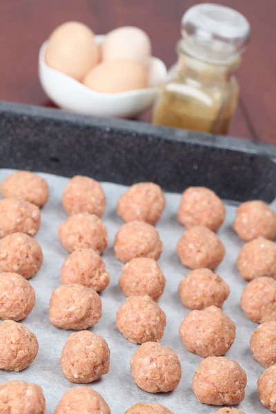 Raw meatballs on baking sheet — Stock Photo, Image