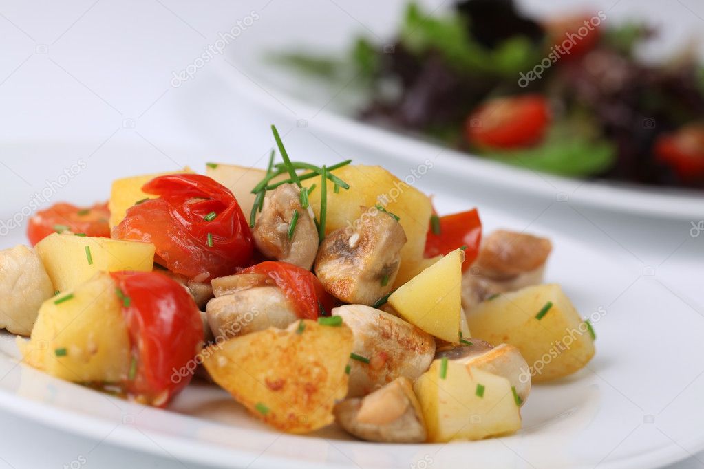 Fried potatoes with mushrooms and cherry tomatoes