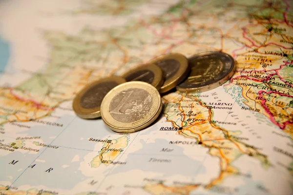 Euro coins on a map of italia