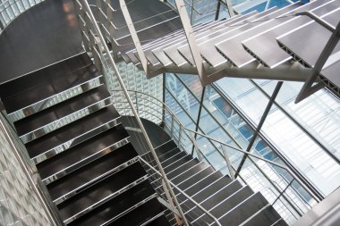 Open stairwell in a modern office building clipart