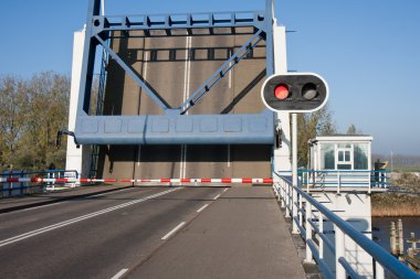 Opened bascule bridge in the Netherlands with red stop sign clipart