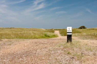 Dunes with wooden distance marker clipart