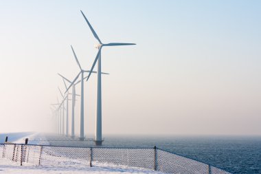 Dutch offshore wind turbines in winter time clipart