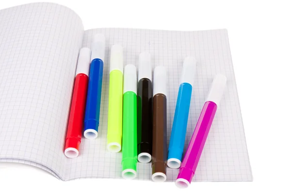 Exercise book with felt-pens isolated over white — Stock Photo, Image