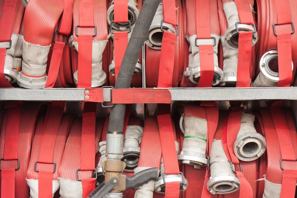 Lapped fire hoses on a fire truck — Stock Photo, Image