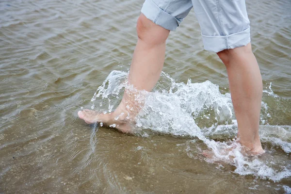 stock image Woman walking through the fresh water