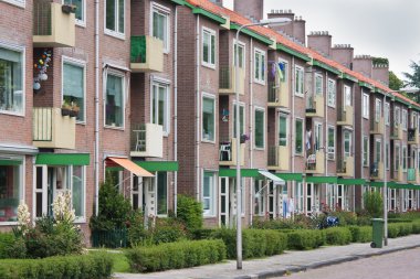 Typical Dutch residential street with flats clipart
