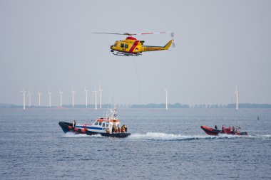 URK, THE NETHERLANDS - JUN 7: The lifeboat of Urk is practicing with a resc clipart