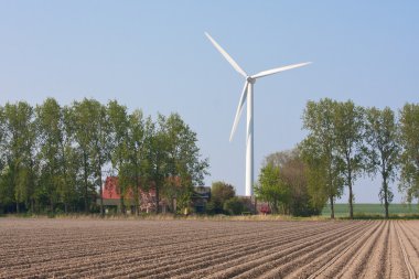 Farmhouse with a windturbine clipart