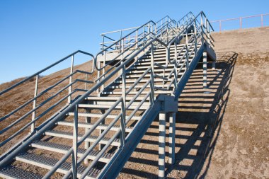 Stairway of stainless steel to the blue sky clipart