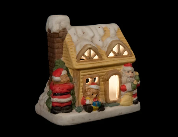 stock image Small christmas house with a candle inside, isolated on a black