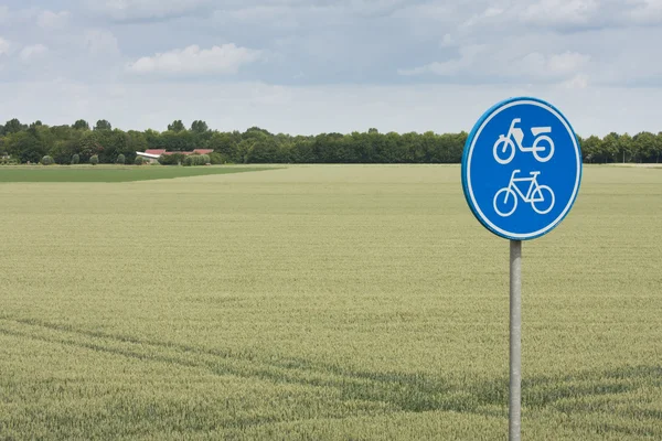 Lalu lintas tanda untuk sepeda dan bersepeda di lanskap pedesaan — Stok Foto