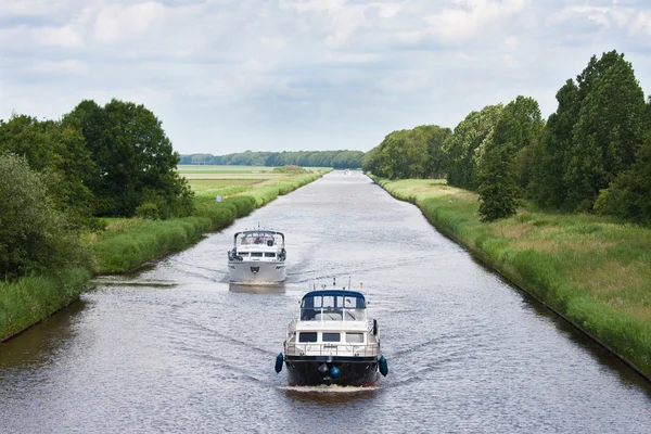 Two yachts sailing in a straight Dutch canal — Stock Photo, Image