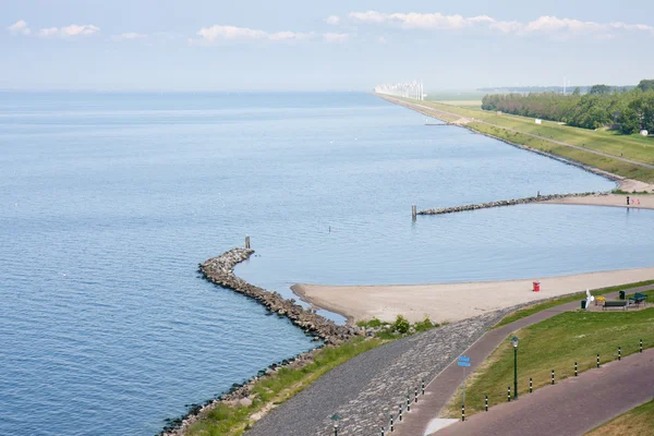 Seafront of a Dutch town with in front a big windfarm — Stock Photo, Image