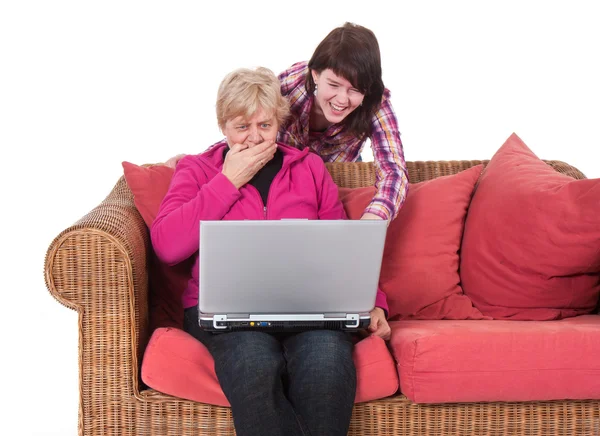 stock image Granddaughter shows her grandma something amazing at her compute