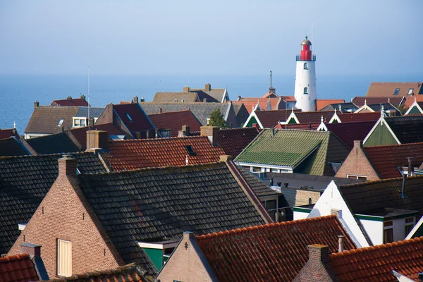 View at the lighthouse and roofs of an old fishing village in th — Stock Photo, Image