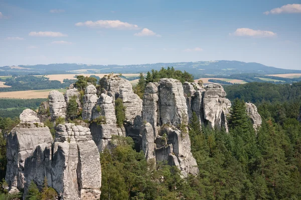 Sandstone pillars arising above the wood in the Czech republic — Stock Photo, Image