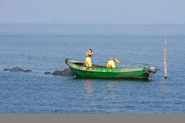 Fishing men inspecting their nets — Stock Photo, Image