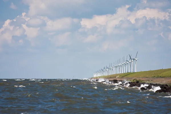 Breakwater with windmills during a heavy storm — Stock Photo, Image