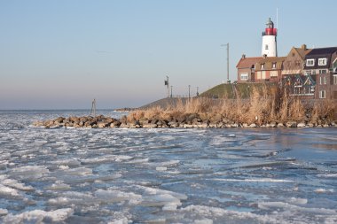 Seafront of Urk from frozen sea in the Netherlands clipart