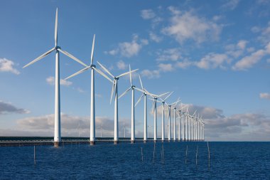 Enormous windmills standing in the sea clipart