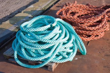 Two nylon ropes at a ship in the harbor