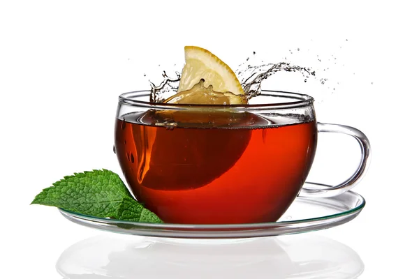 Taza de té con limón y salpicadura —  Fotos de Stock