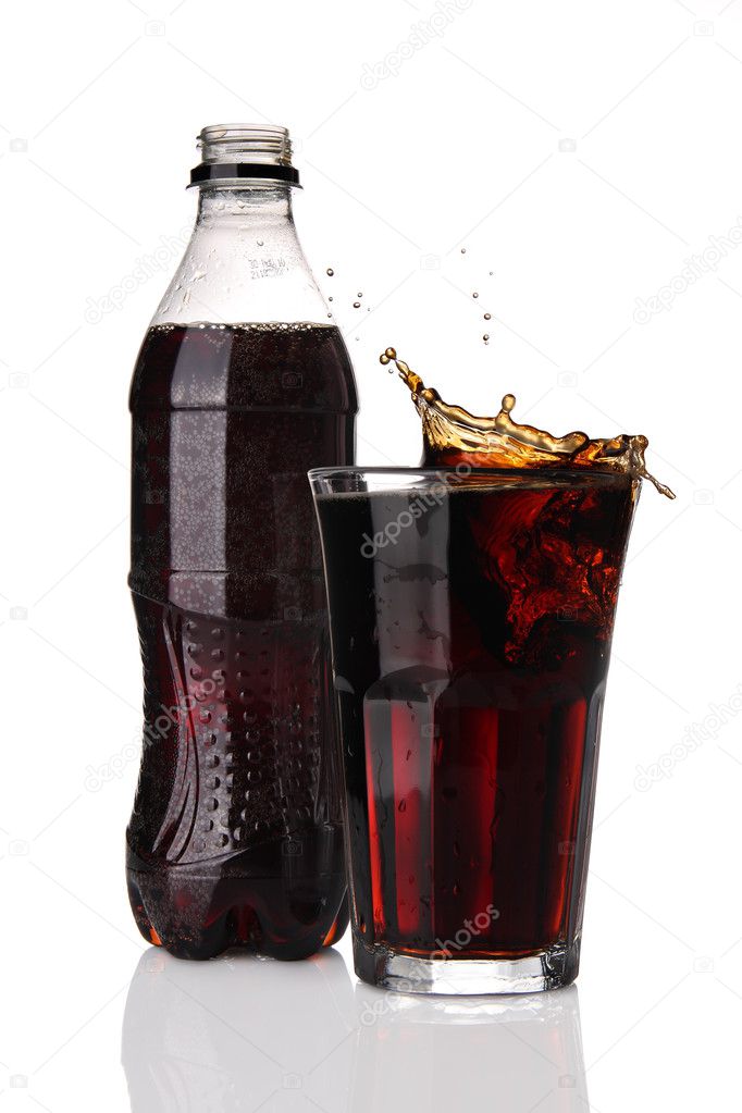 Bottle and glass of cola with splash
