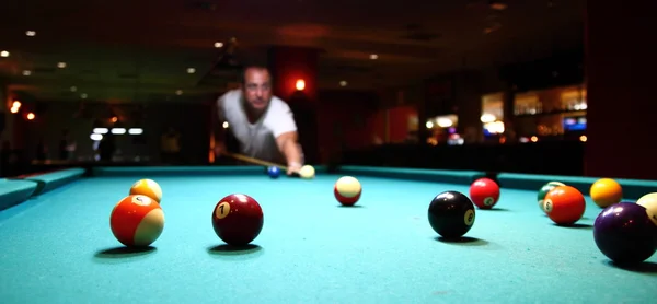 stock image Close up of pool table and balls pictured mid game under billiard hall ligh