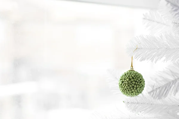 Green bauble on Christmas Tree